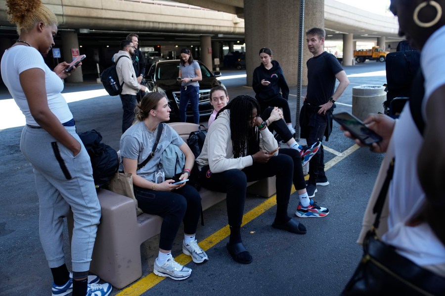 FILE - Players and staff of the New York Liberty WNBA basketball team wait to board buses at Harry Reid International Airport, Wednesday, June 28, 2023, in Las Vegas. The wait for full-time charter flights for WNBA teams finally is over with commissioner Cathy Engelbert announcing the league’s plans to start the program this season, Tuesday, May 7, 2024. (AP Photo/John Locher, File)