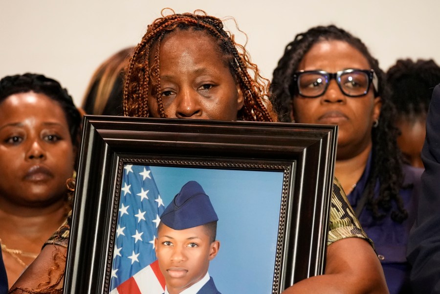 Chantemekki Fortson, mother of Roger Fortson, a U.S. Navy airman, holds a photo of her son during a news conference regarding his death, along with family and Attorney Ben Crump, Thursday, May 9, 2024, in Fort Walton Beach, Fla. Fortson was shot and killed by police in his apartment on May 3, 2024. (AP Photo/Gerald Herbert)