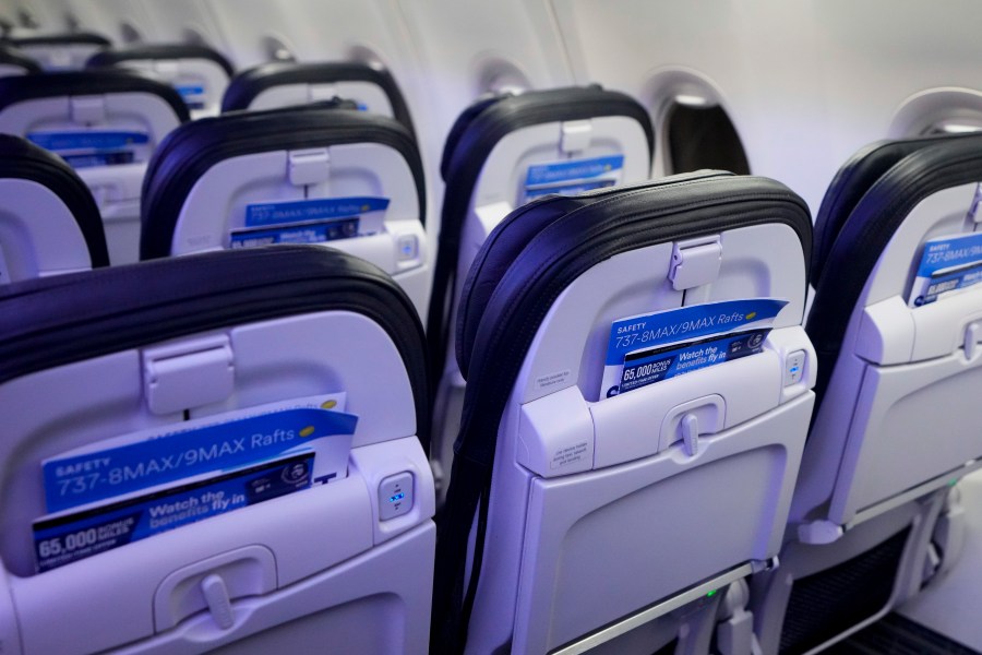 FILE - Safety cards in seat backs are seen on an Alaska Airlines Boeing 737 Max 9 aircraft awaiting inspection at the airline's hangar at Seattle-Tacoma International Airport Jan. 10, 2024, in SeaTac, Wash. The Justice Department says Boeing violated a settlement that let the company avoid criminal prosecution after two deadly crashes involving its 737 Max aircraft. (AP Photo/Lindsey Wasson, File)