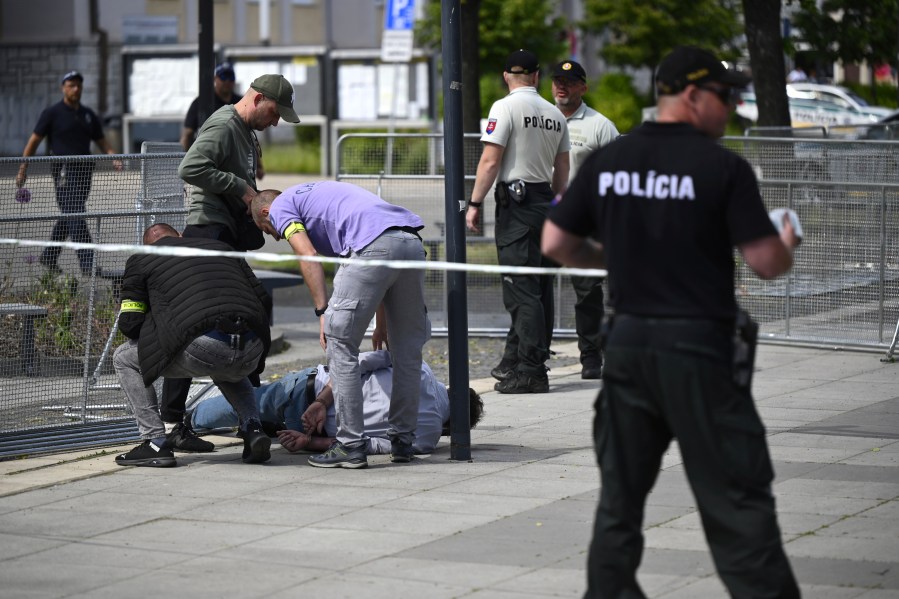 Police arrest a man after Slovak Prime Minister Robert Fico was shot and injured following the cabinet's away-from-home session in the town of Handlova, Slovakia, Wednesday, May 15, 2024. Fico is in life-threatening condition after being wounded in a shooting Wednesday afternoon, according to his Facebook profile. (Radovan Stoklasa/TASR via AP)