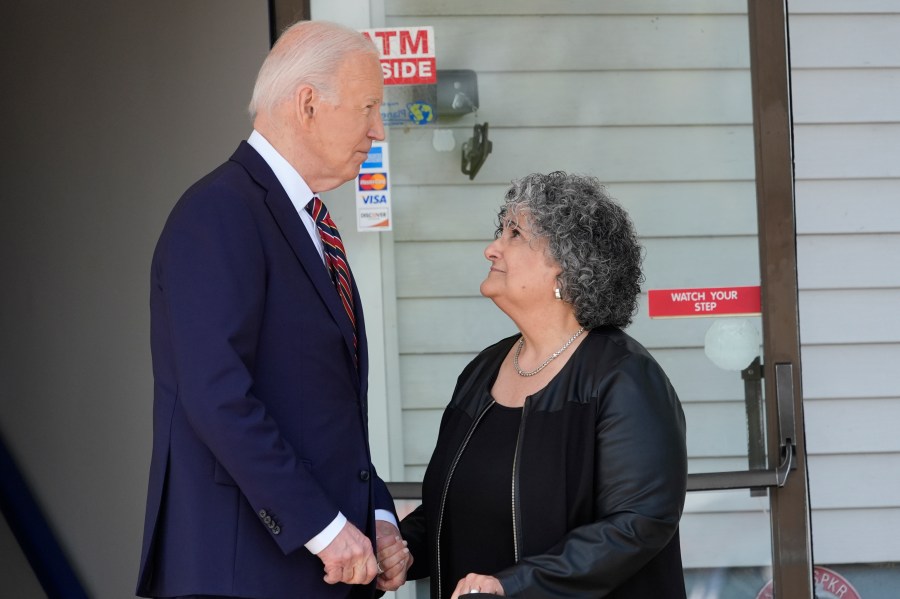 President Joe Biden walks with Lisa Clark as they depart the VFW Post 8641, Tuesday, May 21, 2024, in Nashua, N.H. Clark is an Air Force veteran and Department of Veterans Affairs volunteer. (AP Photo/Alex Brandon)