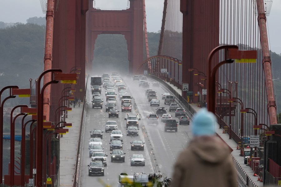 FILE -- A person watches as traffic drives across the Golden Gate Bridge in Sausalito, Calif., on March 1, 2024. The California Senate passed a bill on Tuesday, May 21, 2024, that would eventually require all new cars sold in California to alert drivers once they exceed the speed limit by 10 miles per hour. (AP Photo/Jeff Chiu,File)