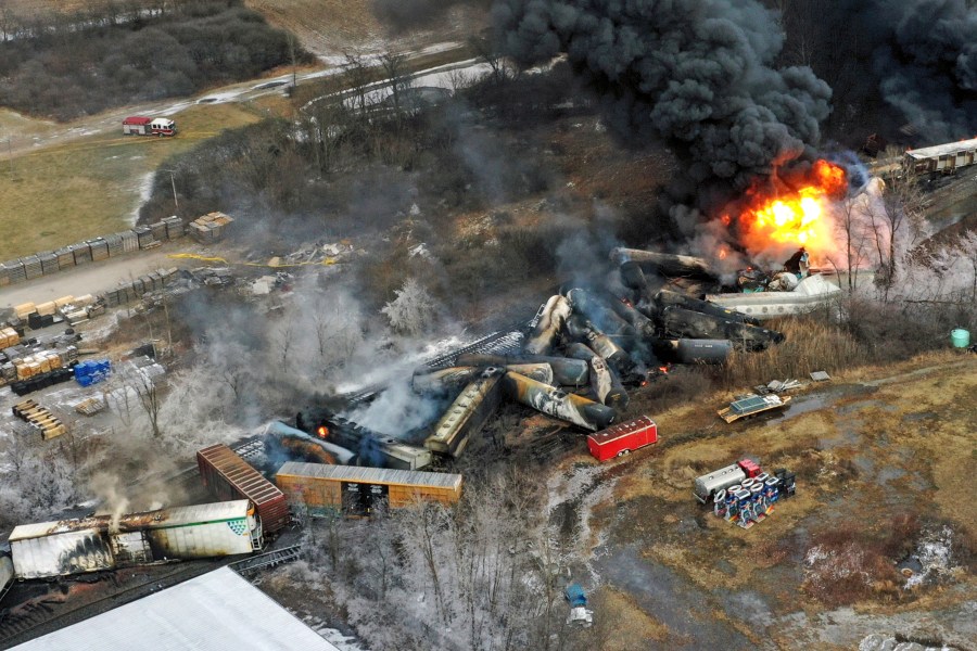 FILE - Debris from a Norfolk Southern freight train lies scattered and burning along the tracks on Feb. 4, 2023, the day after it derailed in East Palestine, Ohio. A federal judge has signed off Tuesday, May 21, 2024, on the $600 million class action settlement over last year's disastrous Norfolk Southern derailment in eastern Ohio, but many people who live near East Palestine are still wondering how much they will end up with out of the deal. (AP Photo/Gene J. Puskar, File)