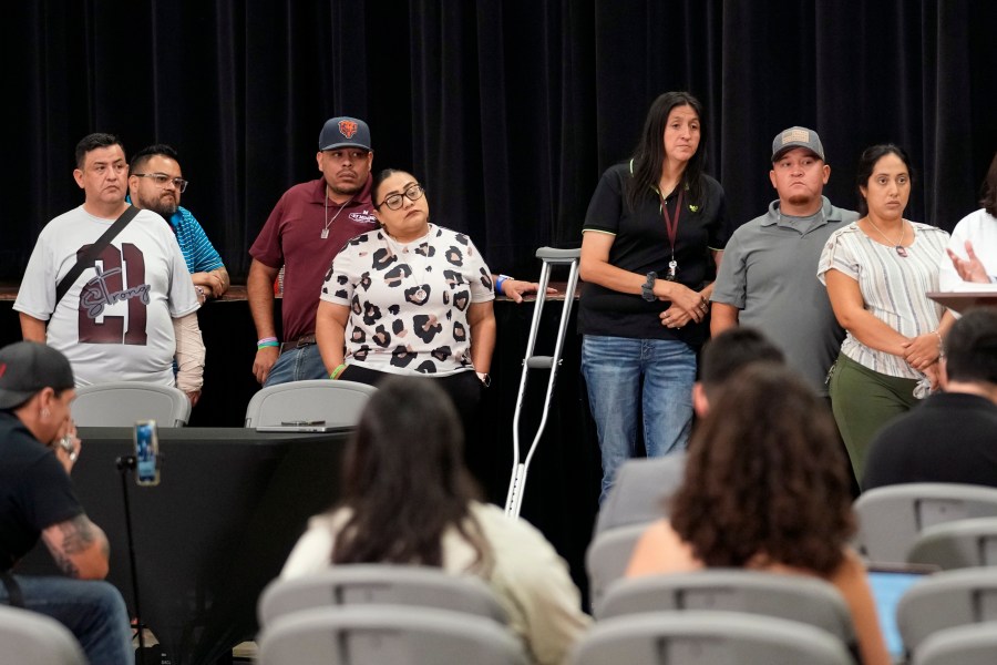 Families of the victims in the Uvalde elementary school shooting listen to attorney Josh Koskoff during a news conference, Wednesday, May 22, 2024, in Uvalde, Texas. The families of 19 of the victims announced a lawsuit against nearly 100 state police officers who were part of the botched law enforcement response. The families say they also agreed a $2 million settlement with the city, under which city leaders promised higher standards and better training for local police. (AP Photo/Eric Gay)