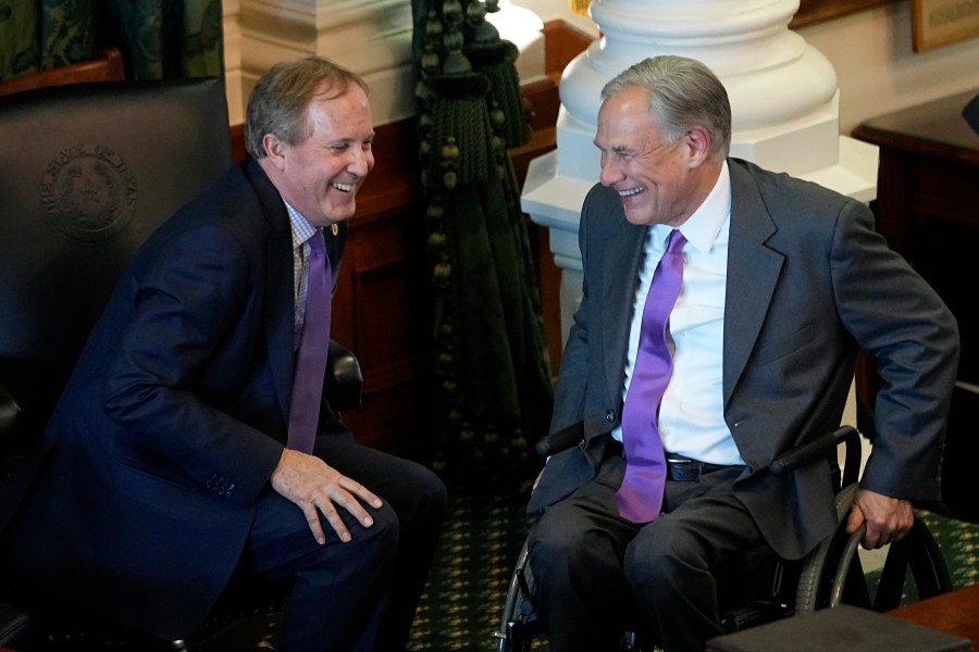 FILE - Texas Attorney General Ken Paxton, left, and Gov. Greg Abbott talk during on the first day of the 88th Texas Legislative Session in Austin, Texas, Jan. 10, 2023. Abbott and Paxton are looking to settle political scores within their own party in the Tuesday, May 27, 2024, primary runoff elections. Abbott is focusing on GOP members who helped defeat his 2023 education plan. Paxton has targeted more than 30 incumbents who voted to impeach him last year on corruption charges. (AP Photo/Eric Gay, File)