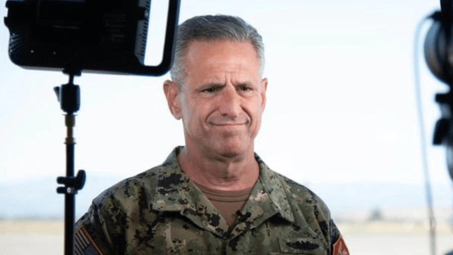 Former Adm. Robert P. Burke is photographed near equipment.