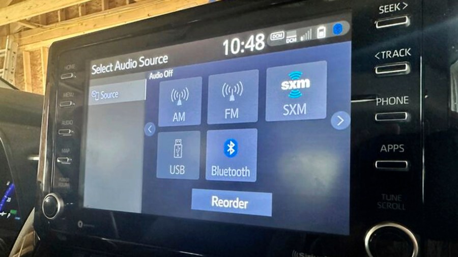 A display screen inside a vehicle shows various radio options, including AM radio, Monday, March 11, 2024, in Bow, N.H.