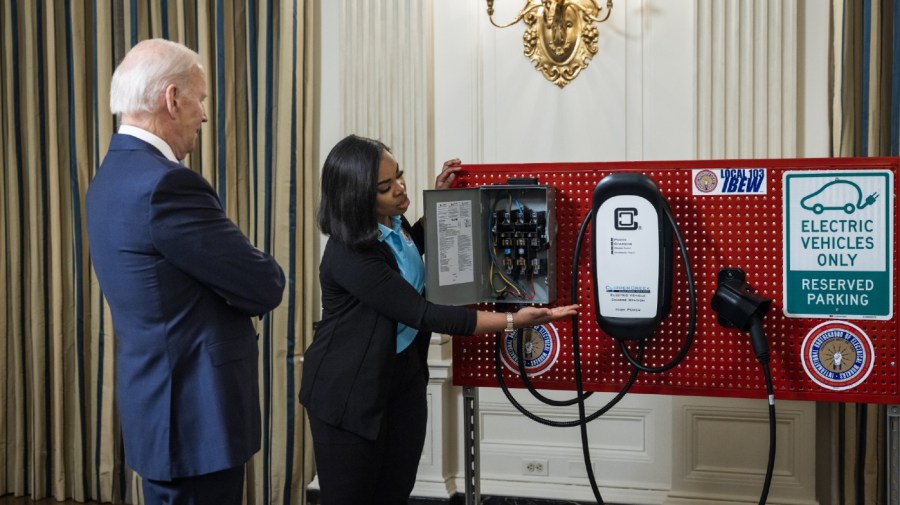 US President Joe Biden, left, views an electric vehicle charger during workforce training demonstrations by labor unions and leading companies in the State Dining Room of the White House in Washington, DC, US, on Wednesday, Nov. 2, 2202.