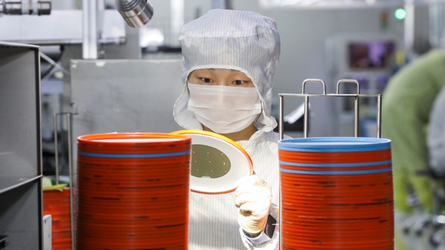 A worker produces chips for mobile phones, cars, LED lighting at a workshop in Huai 'an city, Jiangsu province, China, April 29, 2024.