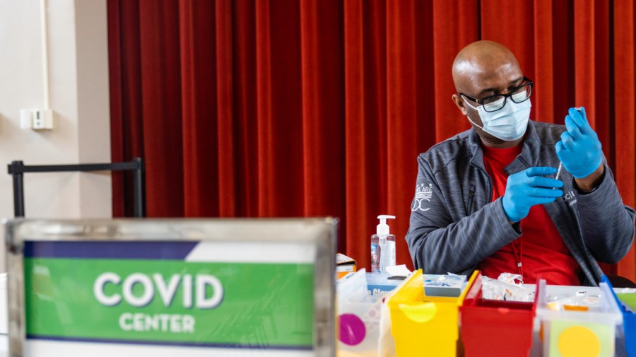 Malik Jaffer, lead nurse, prepares a syringe with a Covid-19 vaccine, at the Peoples Congregational United Church of Christ, the site of the Ward 4 DC Covid Center, in Washington, D.C. on March 31, 2023.