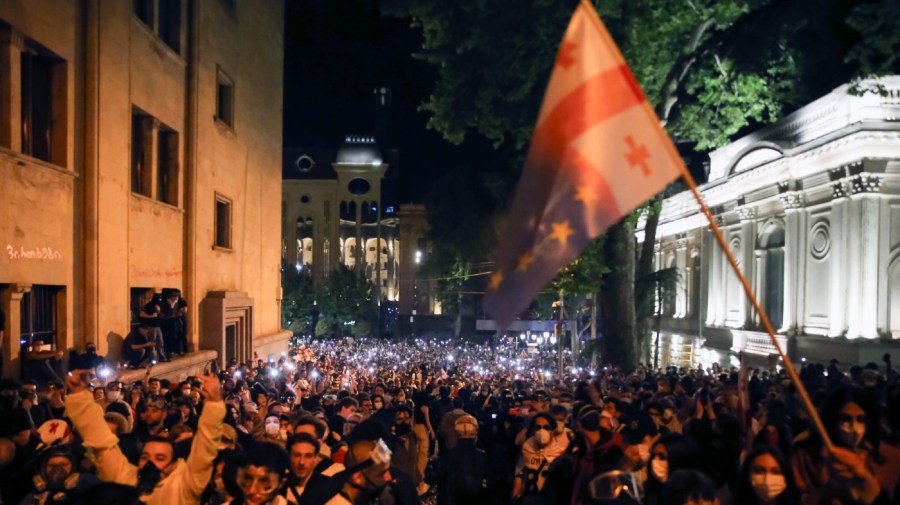 Demonstrators gather during an opposition protest near the Parliament building in Tbilisi, Georgia.