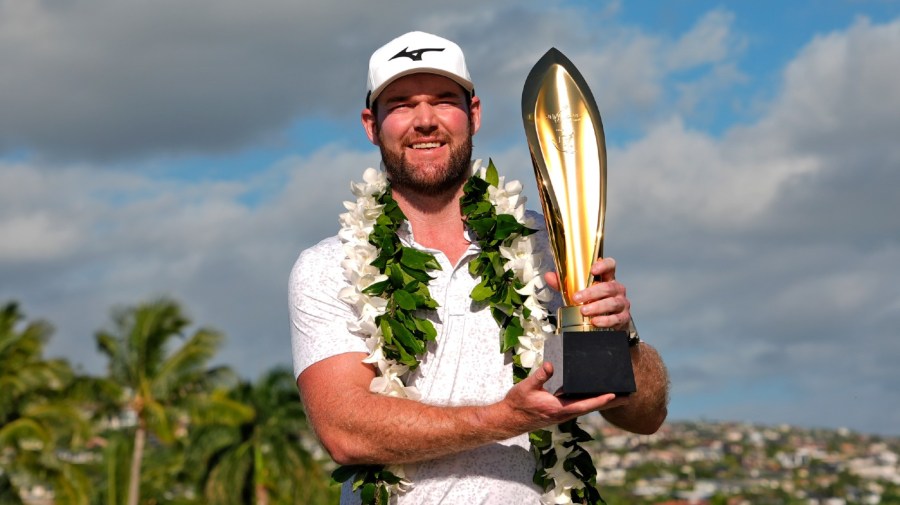 FILE -Grayson Murray holds the trophy after winning the Sony Open golf event, Sunday, Jan. 14, 2024, at Waialae Country Club in Honolulu. Two-time PGA Tour winner Grayson Murray died Saturday morning, May 25, 2024 at age 30, one day after he withdrew from the Charles Schwab Cup Challenge at Colonial(AP Photo/Matt York, File)