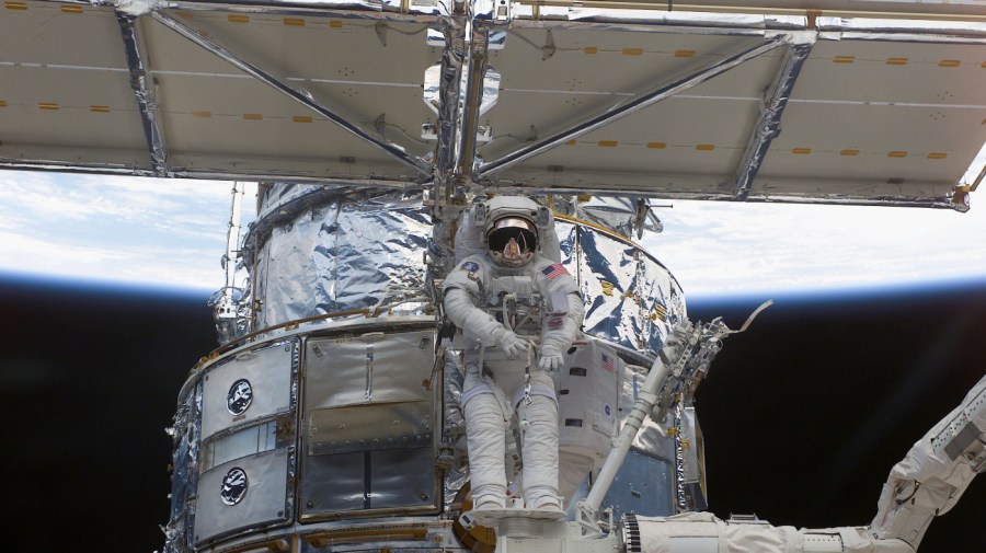 In this image released by the National Aeronautics and Space Administration (NASA), astronaut Richard M. Linnehan works to replace the starboard solar array on the Hubble Space Telescope (HST) during an extravehicular activity (EVA) to try and upgrade some components of the telescope March 4, 2002 in space.