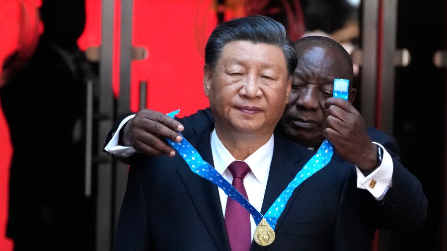 Chinese President Xi Jinping, left, receives the order of South Africa from President Cyril Ramaphosa at Union Building in Pretoria, South Africa, Tuesday, Aug. 22, 2023.