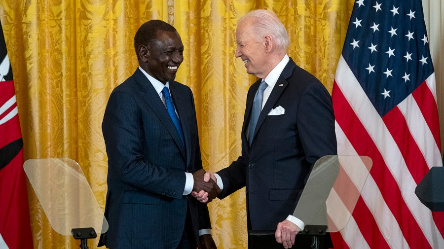 Kenyan President William Ruto shakes hands with President Biden following a press conference.