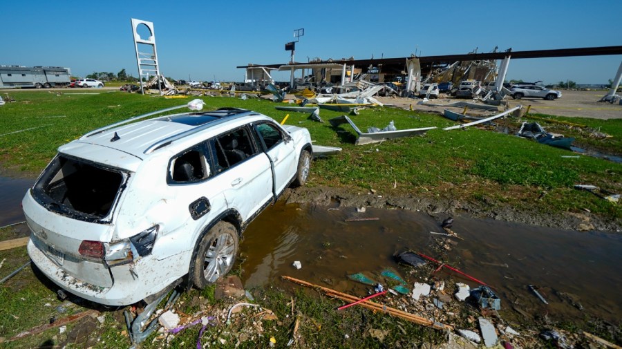 A vehicle rests in a ditch the morning after a tornado rolled through, Sunday, May 26, 2024, in Valley View, Texas. Powerful storms left a wide trail of destruction Sunday across Texas, Oklahoma and Arkansas after obliterating homes and destroying a truck stop where drivers took shelter during the latest deadly weather to strike the central U.S. (AP Photo/Julio Cortez)