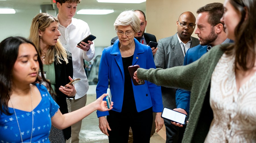 Senator Elizabeth Warren speaks to reporters.