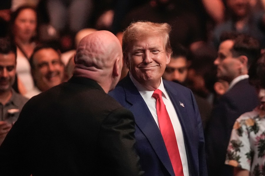 Former President Donald Trump, center right, smiles toward Dana White, front left, while attending the UFC 302 mixed martial arts event Saturday, June 1, 2024, in Newark, N.J. (AP Photo/Frank Franklin II)