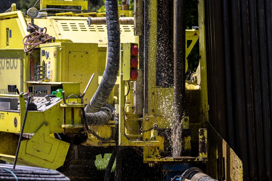 FILE - Groundwater squirts up during drilling for a geothermal heating and cooling system at a home in White Plains, N.Y., May 8, 2023. A community in Framingham, Mass., will soon become one of the first in the U.S. to be heated with geothermal connected to each other. (AP Photo/Julia Nikhinson, File)