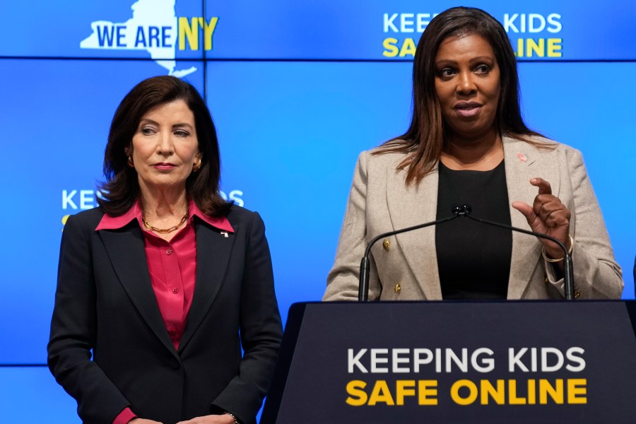 FILE - New York Gov. Kathy Hochul, left, listens as Attorney General Letitia James speaks during a news conference in New York, Oct. 11, 2023. New York lawmakers on Tuesday, June 4, said they were finalizing legislation that would allow parents to block their children from getting social media posts curated by a platform's algorithm, a move to rein in feeds that critics argue keep young users glued to their screens. Hochul and James have been advocating for the regulations since October, facing strong pushback from the tech industry. (AP Photo/Seth Wenig, File)