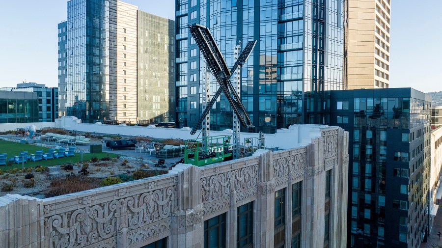 FILE - An "X" sign rests atop the company headquarters in downtown San Francisco, on July 28, 2023. Australia’s online safety watchdog said on Wednesday, June 6, 2024, she had dropped her Federal Court case that attempted to force X Corp. to take down a video of a Sydney bishop being stabbed. (AP Photo/Noah Berger, File)