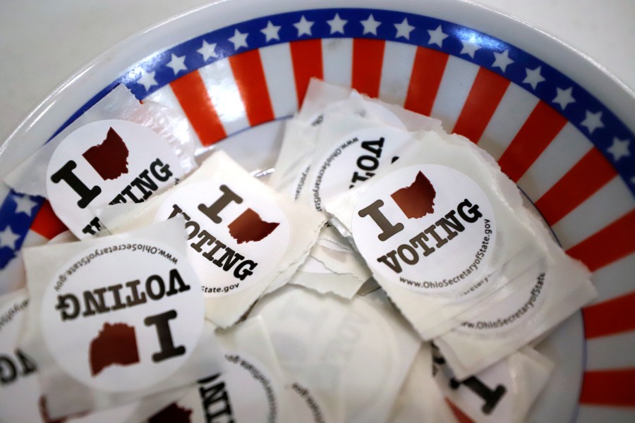 FILE - This is a bowl of stickers for those taking advantage of early voting, Sunday, March 15, 2020, in Steubenville, Ohio. Small business owners are more undecided about the election than the general public. That's according to a new survey by Goldman Sachs 10,000 Small Businesses Voices. (AP Photo/Gene J. Puskar, File)