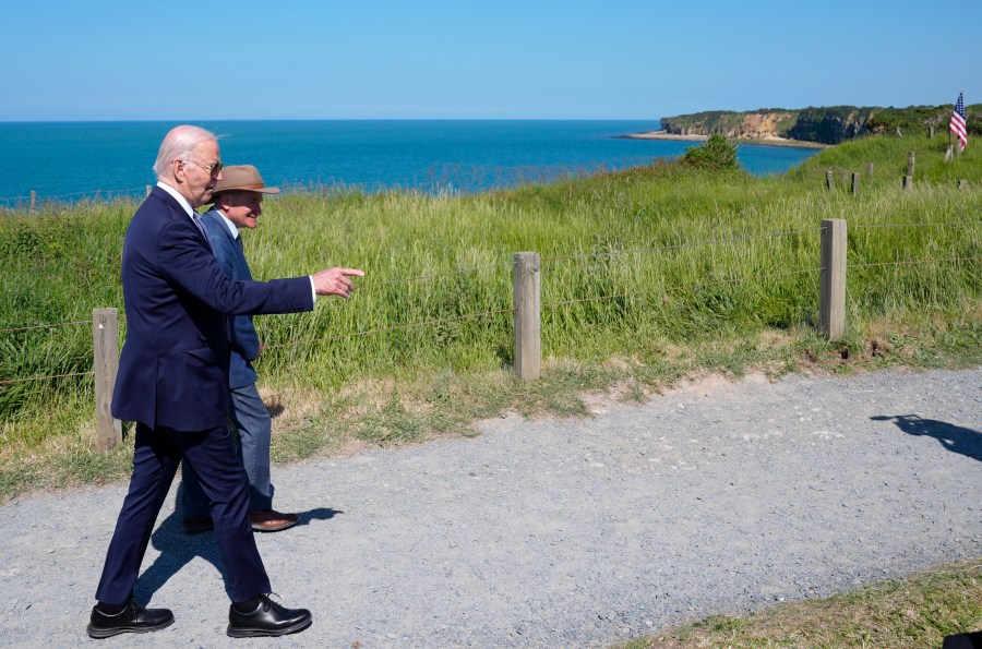 President Joe Biden walks with Scott Desjardins, superintendent of Normandy American Cemetery and Pointe du Hoc, after delivering a speech on the legacy of Pointe du Hoc, and democracy around the world, Friday, June 7, 2024, in Normandy, France. (AP Photo/Evan Vucci)