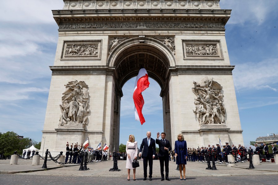 French President Emmanuel Macron, lcenter right, stands with US President Joe Biden, First Lady Jill Biden and Brigitte Macron, right, during a ceremony at the Arc de Triomphe, Saturday June 8, 2024 in Paris. President Joe Biden is being feted by French President Emmanuel Macron with a state visit Saturday, as the two allies aim to show off their partnership on global security issues and move past trade tensions. (Ludovic Marin, Pool via AP)