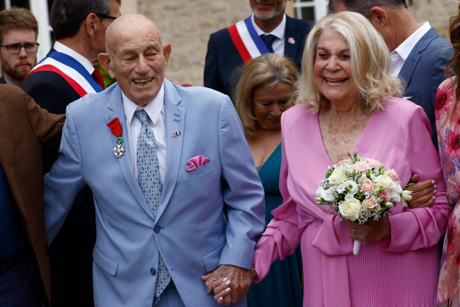 US WWII veteran Harold Terens, 100, left, and Jeanne Swerlin, 96, arrive to celebrate their wedding at the town hall of Carentan-les-Marais, in Normandy, northwestern France, on Saturday, June 8, 2024. Together, the collective age of the bride and groom was nearly 200. But Terens and his sweetheart Jeanne Swerlin proved that love is eternal as they tied the knot Saturday inland of the D-Day beaches in Normandy, France. (AP Photo/Jeremias Gonzalez)