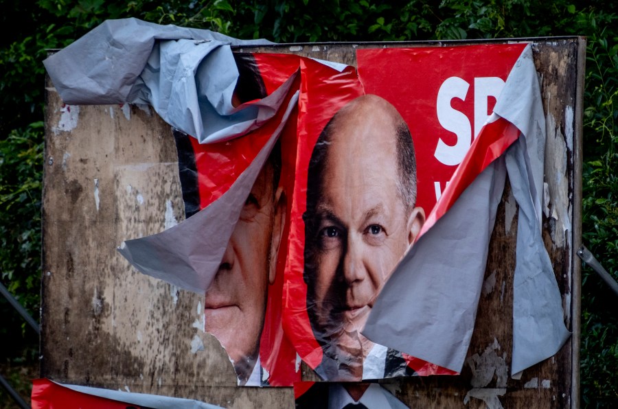 A damaged election poster shows German Chancellor Olaf Scholz in Frankfurt, Germany, Monday, June 10, 2024. (AP Photo/Michael Probst)