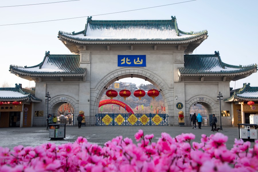 Tourists walk past a gateway with the name "Beishan" seen at the Beishan Park in northeastern China's Jilin province on Jan 23, 2020. Four instructors from Iowa's Cornell College teaching at Beihua University in northeastern China were attacked in the Beishan public park, reportedly with a knife, officials at the U.S. school and the State Department said Tuesday, June 11, 2024. (Zhu Wanchang/CNS Photos via AP)