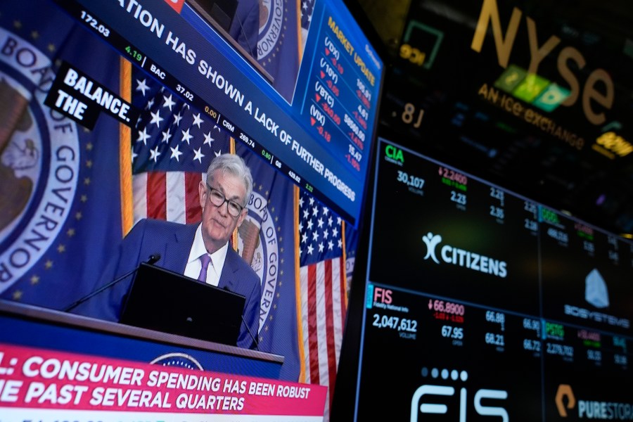 FILE - A screen displays a news conference with Federal Reserve Chairman Jerome Powell on the floor at the New York Stock Exchange in New York, May 1, 2024. On Wednesday, June 12, 2024, the Federal Reserve ends its latest meeting by issuing a policy statement, updating its economic and interest-rate projections and holding a news conference with Powell. (AP Photo/Seth Wenig, File)