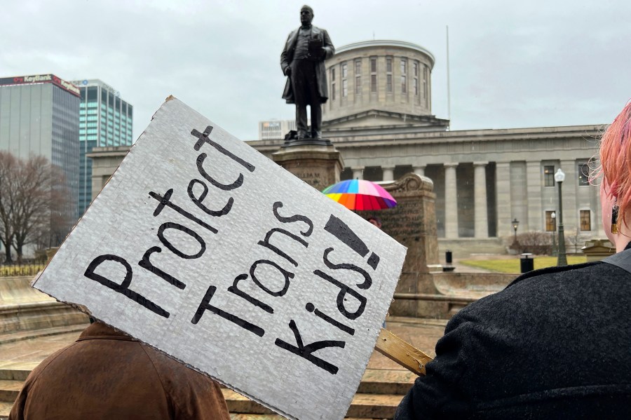 FILE - Demonstrators advocating for transgender rights and healthcare stand outside of the Ohio Statehouse on Jan. 24, 2024, in Columbus, Ohio. In a preliminary injunction granted Thursday, U.S. District Judge Terry A. Doughty called the new rule an "abuse of power" and a "threat to democracy." His order blocks the rule in Louisiana, which filed a challenge to the rule in April, and in Mississippi, Montana and Idaho, which joined the suit. (AP Photo/Patrick Orsagos, File)