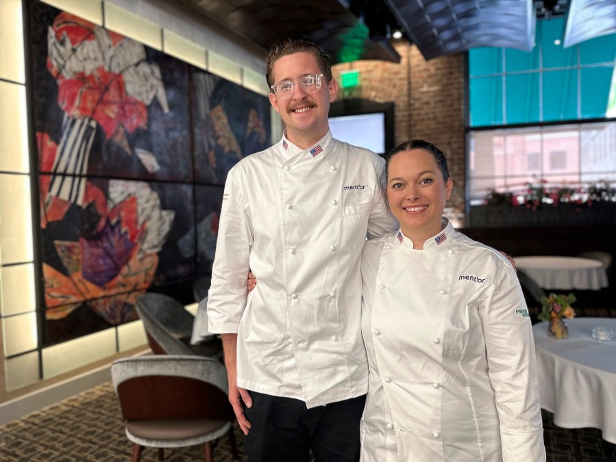 Bradley Waddle, left, stands with Stefani De Palma at Emeril’s restaurant in New Orleans, Thursday, June 13, 2024. De Palma is the head chef and Waddle is the commis chef for Team USA at the Bocuse d’Or Americas culinary competition in New Orleans this week. (AP Photo/Stephen Smith)