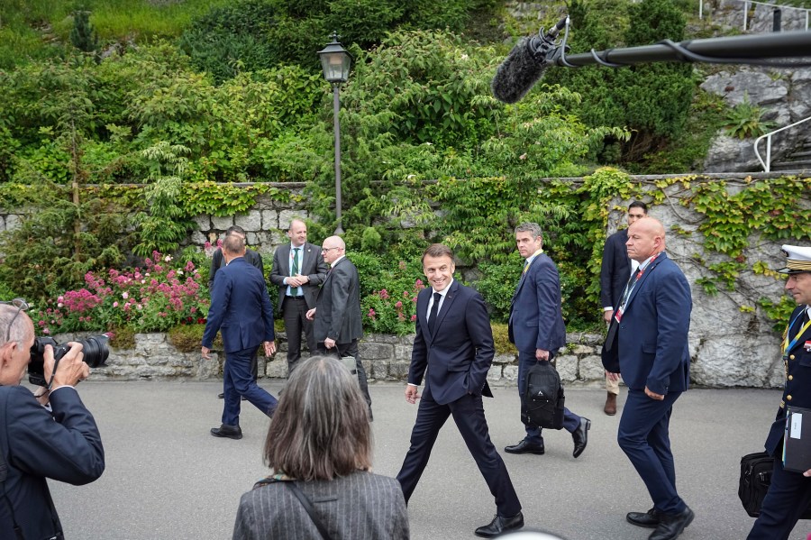 French President Emmanuel Macron, center, arrives at the Ukraine peace summit in Buergenstock, Switzerland, Saturday, June 15, 2024. Switzerland is hosting scores of world leaders this weekend to try to map out the first steps toward peace in Ukraine. (AP Photo/Laurent Cipriani)