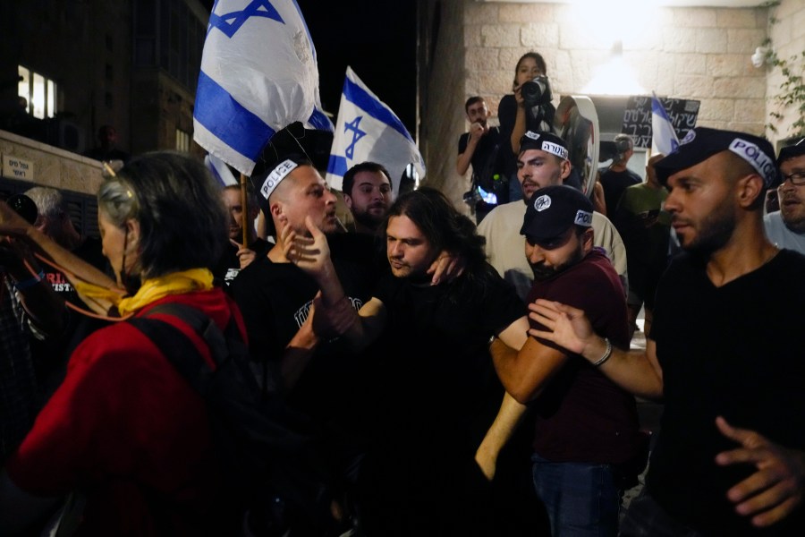 Israeli police officers detain a demonstrator during a protest against Israeli Prime Minister Benjamin Netanyahu's government, demanding new elections and the release of the hostages held in the Gaza Strip by the Hamas militant group, in Jerusalem, Monday, June 17, 2024. (AP Photo/Ohad Zwigenberg)