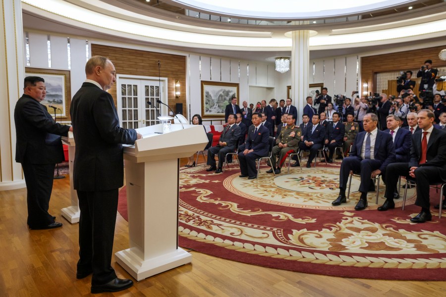 Russian President Vladimir Putin, foreground, and North Korea's leader Kim Jong Un, left, speak to the media after their talks in Pyongyang, North Korea, on Wednesday, June 19, 2024. (Gavriil Grigorov, Sputnik, Kremlin Pool Photo via AP)