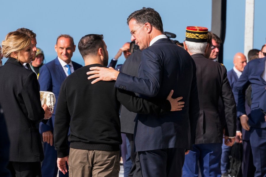 FILE - Ukrainian President Volodymyr Zelenskyy, left, talks to Netherland's Prime Minister Mark Rutte at the end of an international ceremony to mark the 80th anniversary of D-Day at Omaha Beach in Saint-Laurent-sur-Mer, Normandy, France, Thursday, June 6, 2024. Over the course of more than a dozen years at the top of Dutch politics, Mark Rutte got to know a thing or two about finding consensus among fractious coalition partners. Now he's going to bring the experience of leading four Dutch multiparty governments to the international stage as NATO's new secretary general. (AP Photo/Virginia Mayo, File)