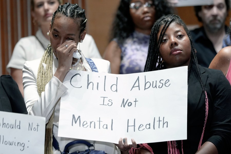 Victims are emotional during a news conference with survivors of abused and neglected youth at residential treatment facilities (RTFs) and advocates, on the need for Congress to act to protect children and reform RTFs, Wednesday, June 12, 2024, on Capitol Hill in Washington. (AP Photo/Mariam Zuhaib)