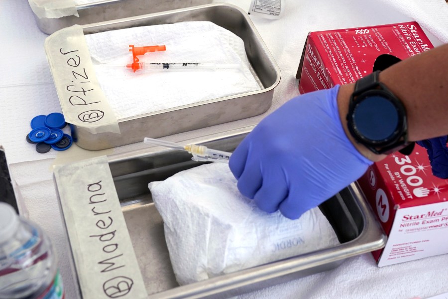 FILE - Syringes with vaccines are prepared at the L.A. Care and Blue Shield of California Promise Health Plans' Community Resource Center where they were offering members and the public free flu and COVID-19 vaccines Oct. 28, 2022, in Lynwood, Calif. (AP Photo/Mark J. Terrill, File)