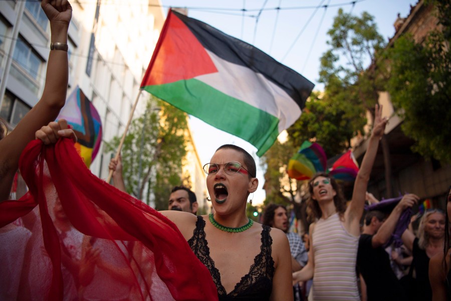 FILE — Protesters shout slogans against Israel's military operation in Gaza Strip during the annual Pride parade, in Athens, Greece, June 15, 2024. At Pride events across the U.S, internal tensions over the ongoing war between Israel and Hamas in Gaza have seeped into the festivities, spurring boycotts and demonstrations at marches and exposing divisions within a movement firmly rooted in protest. (AP Photo/Michael Varaklas, File)