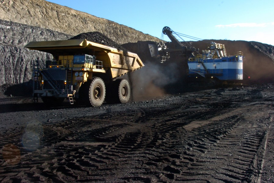 FILE - A haul truck with a 250-ton capacity carries coal after being loaded from a nearby mechanized shovel at the Spring Creek strip mine near Decker, Mont., Nov. 15, 2016. The mine is in the Powder River Basin of Montana and Wyoming, a sparsely populated region with the largest coal mines in the U.S., which is the front line in the political battle over the fuel. (AP Photo/Matthew Brown, File)