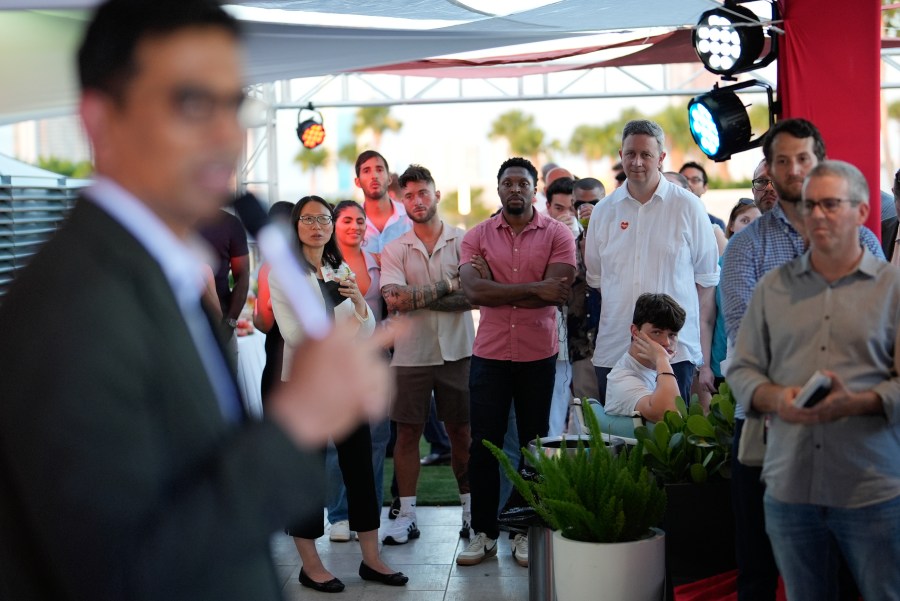 Guests look on as Uma Valeti, CEO and founder of Upside Foods, speaks during a pop-up tasting of the company's "lab-grown" meat, Thursday, June 27, 2024, in Miami. As Florida's ban on lab-grown meat is set to go into effect next week, one manufacturer hosted a tasting party, serving up cultivated chicken tostadas to dozens of attendees on a rooftop in Miami's Wynwood neighborhood. (AP Photo/Rebecca Blackwell)