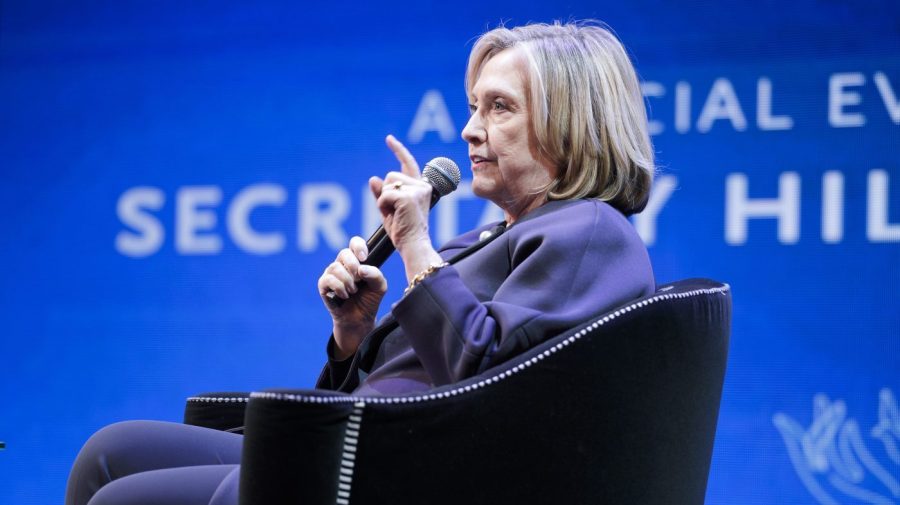 Former Secretary of State Hillary Clinton gestures while speaking at an event.