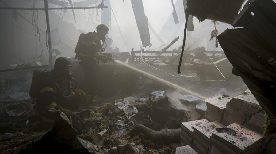 Firefighters hose down a fire in a printing house.