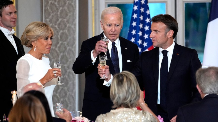 French President Emmanuel Macron, his wife Brigitte Macron, and President Biden toast at a state dinner.