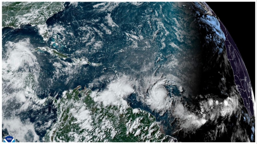 This National Oceanic and Atmospheric Administration satellite image taken at 4:20pm EDT shows hurricane Beryl, lower center right, as it strengthens over the Atlantic Ocean and churns toward the southeast Caribbean on Saturday, June 29, 2024. (NOAA via AP)