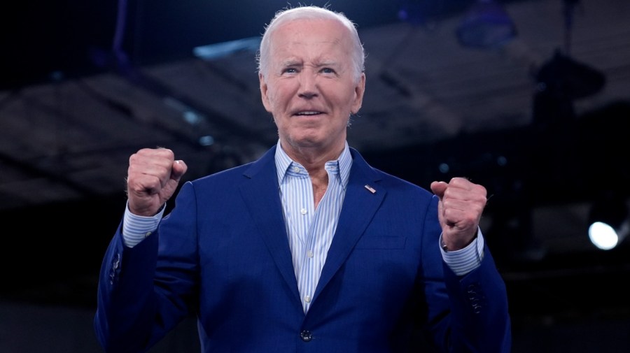 President Biden holds up his fists at at rally.