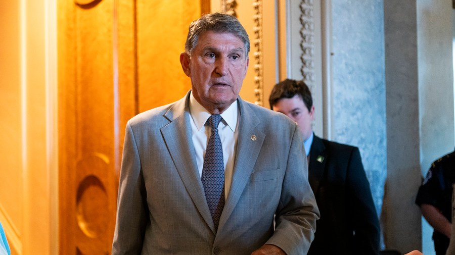 Senator Joe Manchin walks through the Capitol.