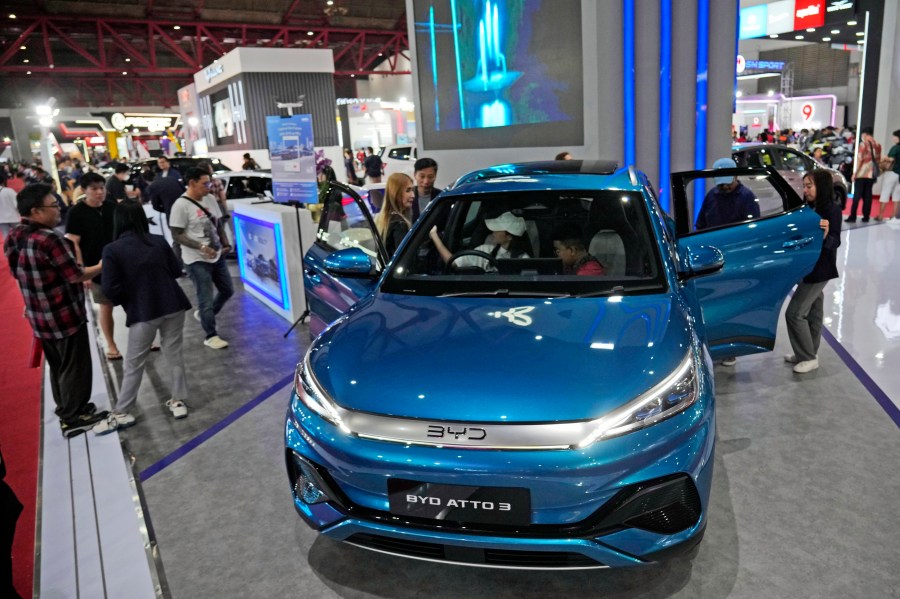 People inspect electric vehicles made by Chinese automaker BYD during an auto fair in Jakarta, Indonesia, Wednesday, June 19, 2024. Investment in electric vehicle manufacturing is booming in Morocco, a country that neighbors Europe and enjoys a free trade agreement with the United States. That's partially because Chinese firms see it as a side door to access the U.S. market and new Biden administration subsidies designed to shut them out. (AP Photo/Achmad Ibrahim)